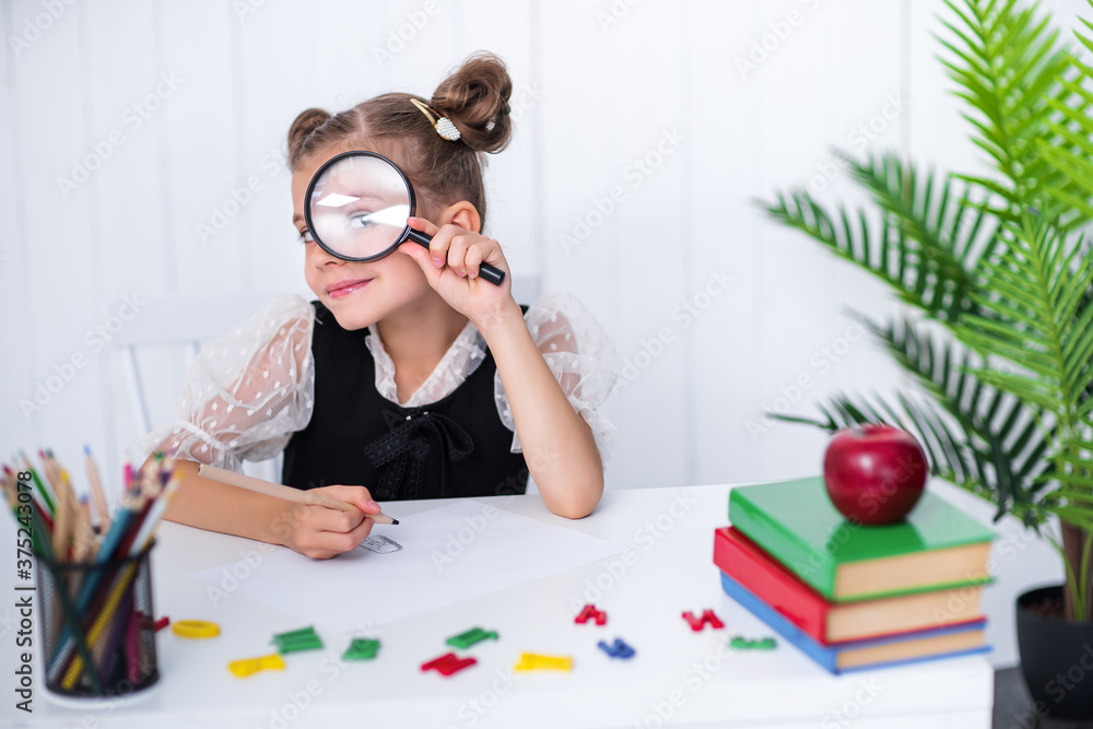 Little school girl express positive and negative emotions through a magnifying glass. Go back to school. Educat how to express feelings. Little school girl express positive and negative emotions through a magnifying glass. Go back to school. Educat how to express feelings.