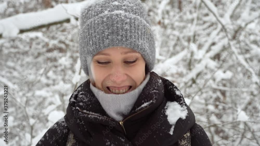 Beautiful young woman having fun in winter forest and enjoying beautiful snowfall. Concept of winter holidays. Beautiful young woman having fun in winter forest and enjoying beautiful snowfall. Concept of winter holidays.