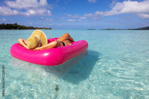 floating on an inflatable toy during vacation on tropical island in Bora Bora photo