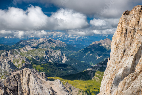 Mountain landscape from Marmolada mountain peak in italian alps against blue sky