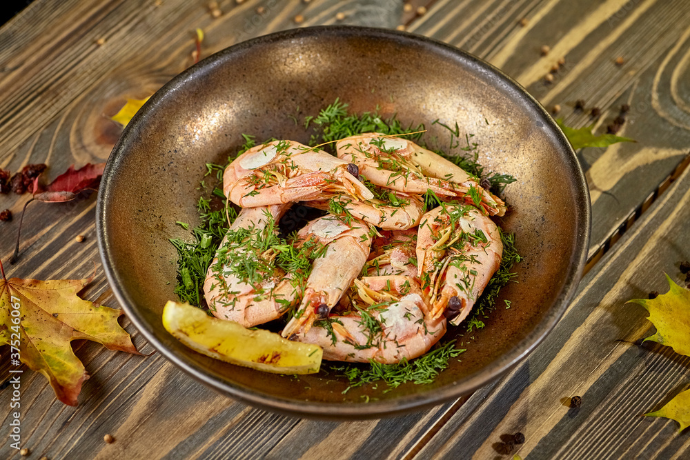 Boiled prawns with lemon and dill are on a plate Boiled prawns with lemon and dill are on a plate