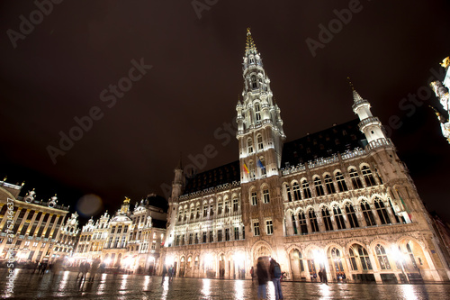 Panoramic night view of grand place of Brussels ( Belgium ) during rain. Long time exposure. The grand palace on the right. its Baroque style is part of UNESCO world heritage