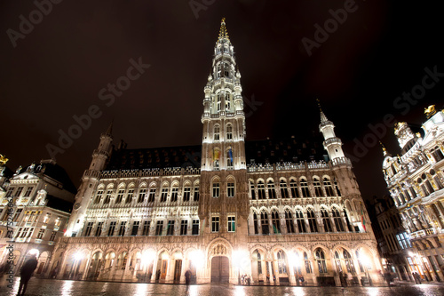 Panoramic night view of grand place of Brussels ( Belgium ) during rain. Long time exposure. The grand palace on the right. its Baroque style is part of UNESCO world heritage