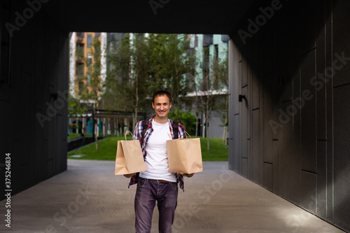 delivery man with paper containers for takeaway food.