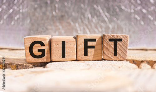 Gift word concept written on wooden cubes on wooden table