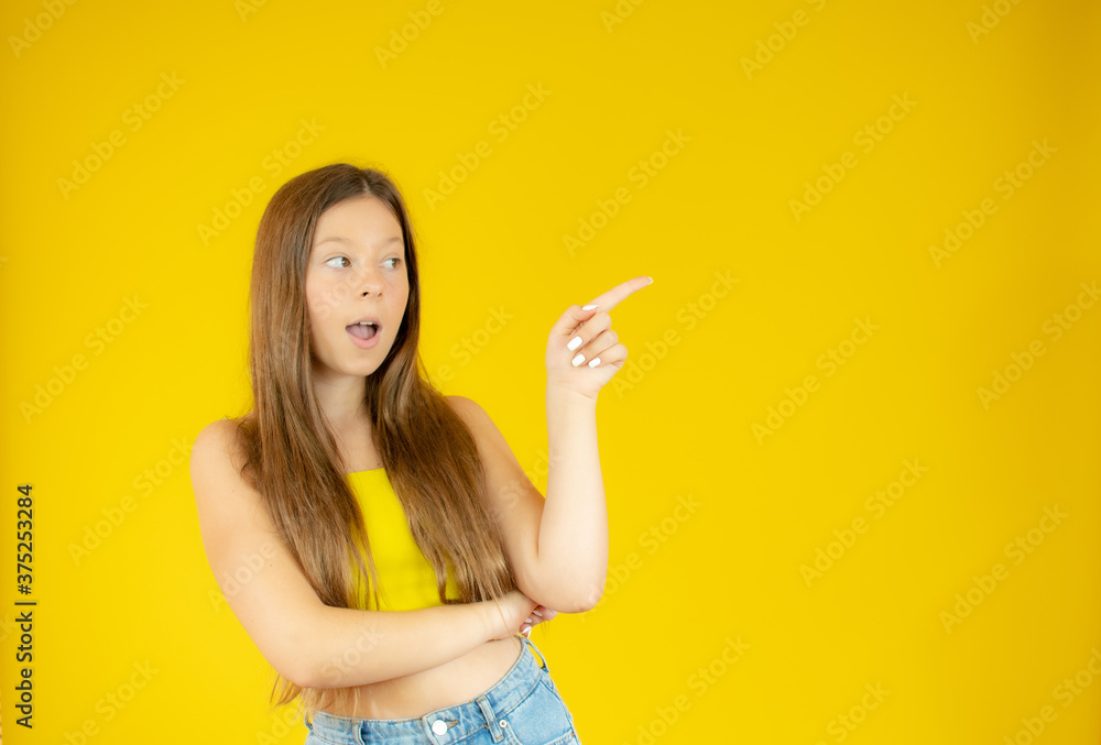 Beautiful girl with long hair pointing something Beautiful girl with long hair pointing something