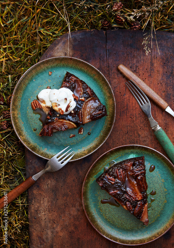 Rum spiced pecan and pear chocolate upside down cake slice with whipped cream