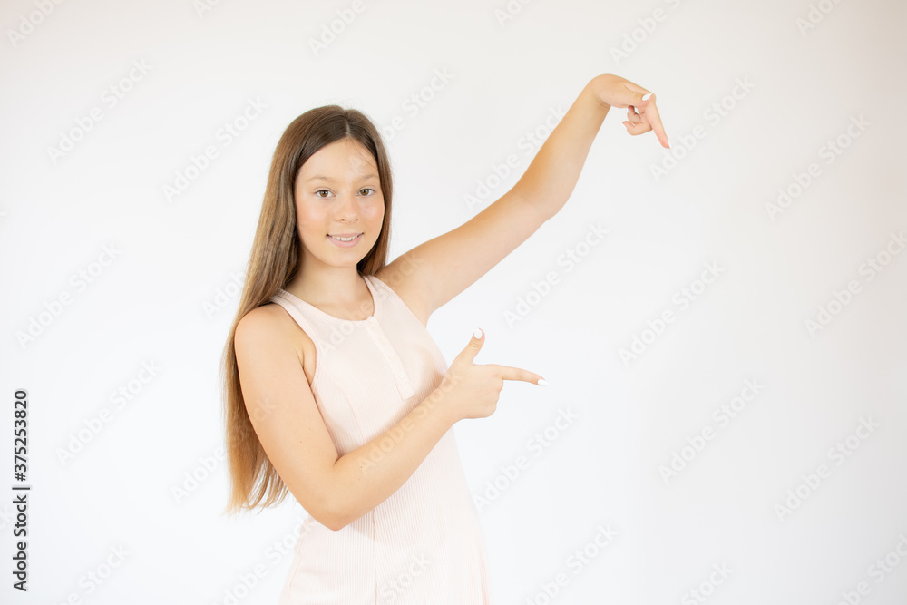 Smiling beautiful girl with long hair pointing something Smiling beautiful girl with long hair pointing something