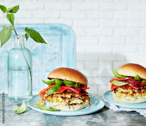 Close up of crispy corn fritter sandwich on table