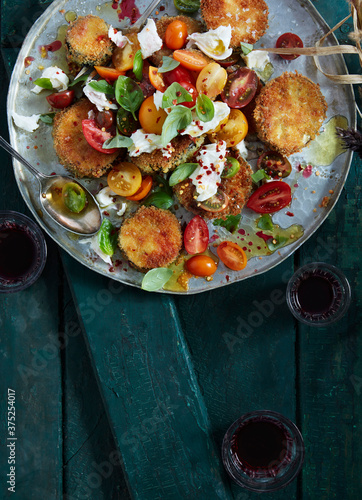 Overhead view of crispy eggplant salad with tomatoes and burrata cheese