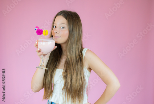 Beautiful girl with long hair drinking a smoothie © Danko