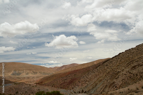 View of the arid desert, brown mountains and valley under a beautiful sky. 