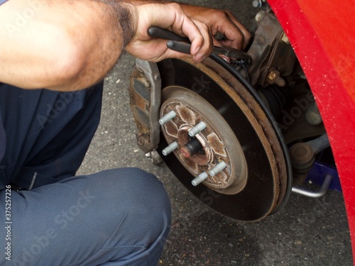 mechanic changing a wheel of a car
