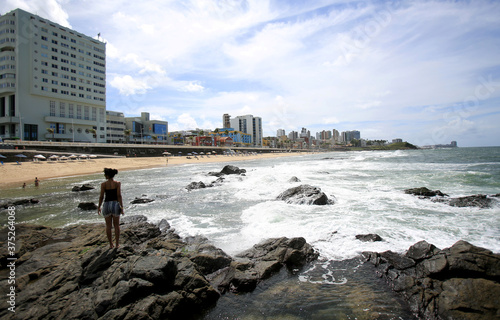 salvador, bahia / brazil - august 28, 2018: people are seen next to rocks on Barra beach in the city of Salvador. photo