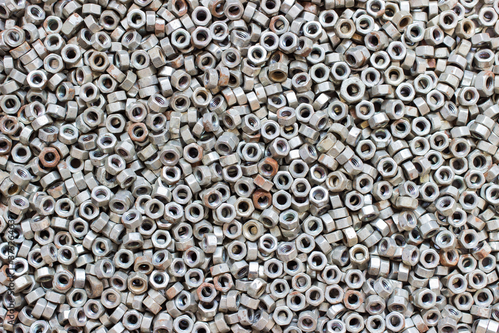 Old nuts. Texture for background. Stack of nuts for bolts and screws. Female screw. Screw-nut. Internal screw. Old nuts. Texture for background. Stack of nuts for bolts and screws. Female screw. Screw-nut. Internal screw.