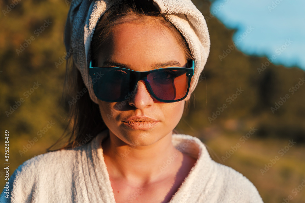 Front view close up of young fashionable caucasian woman standing in nature with towel on head in sunny summer day wearing eyeglasses - Social norms equality confused generation concept Front view close up of young fashionable caucasian woman standing in nature with towel on head in sunny summer day wearing eyeglasses - Social norms equality confused generation concept