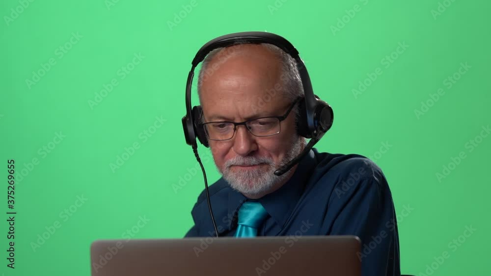Cheerful businessman wear headset making conference video call on laptop. Male professional call center agent, hr manager having distance webcam chat job interview on computer in office. Green screen Cheerful businessman wear headset making conference video call on laptop. Male professional call center agent, hr manager having distance webcam chat job interview on computer in office. Green screen