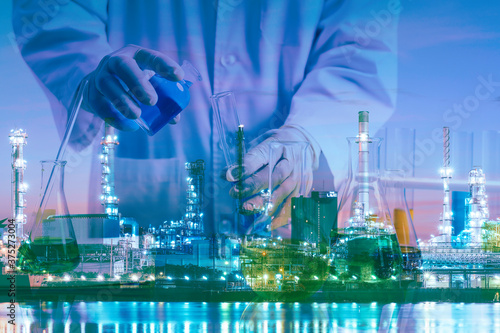 Petrochemical concept composite image of laboratory testing tube on the Oil&Gas refinery background showing the concept of high quality control of product