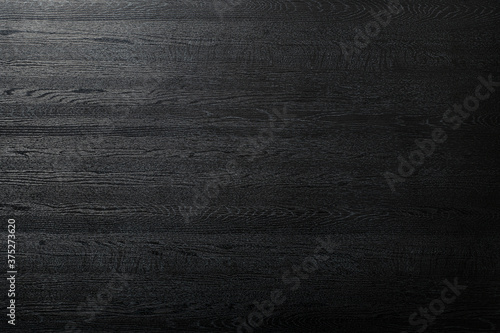 艶のある黒い木製のボードの背景テクスチャー
