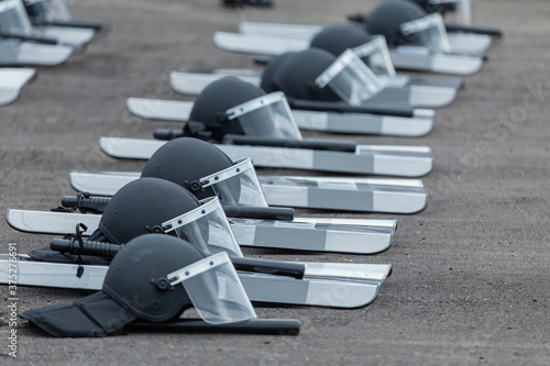 Fototapeta A riot police helmet put on the ground, ready to use,Suppress the riot, put on protection against danger