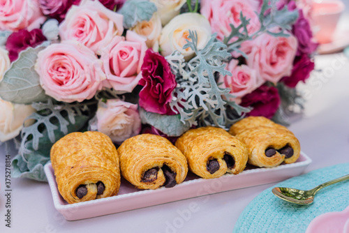 Close up of rolls with chocolate with pink roses
