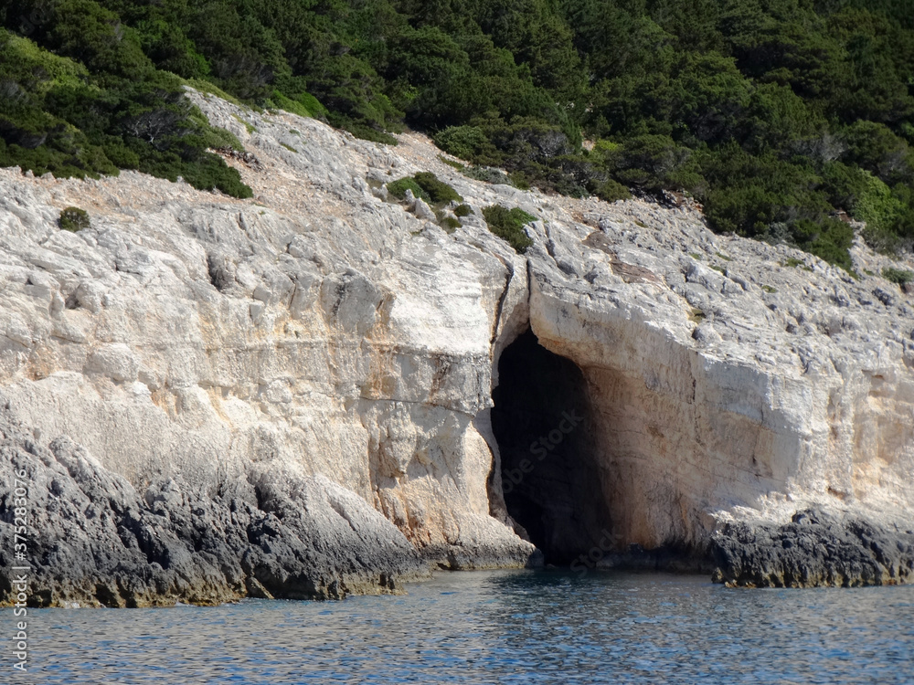 Natural sea caves of Ionian island near Nydri village in Lefkada in Greece. Tourists visit Nydri for vacations for its natural mountainous and seascape, also choices of bars and restaurants.