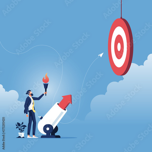 Goal Achievement concept-Businessman launching a business arrow through cannon, Businessman with torch shooting uphill arrow from cannon stock