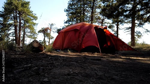 Time lapse of a couple assembling and raising a tent in the mountains