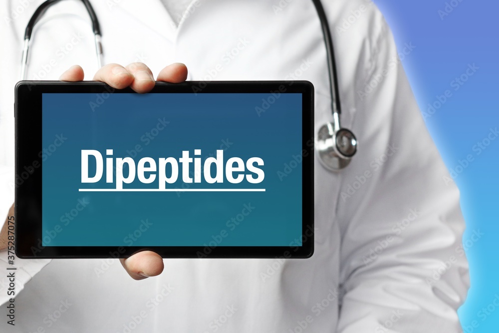 Dipeptides. Doctor holds a tablet computer in his hand. Close up. Text is on the display. Blue Background Dipeptides. Doctor holds a tablet computer in his hand. Close up. Text is on the display. Blue Background