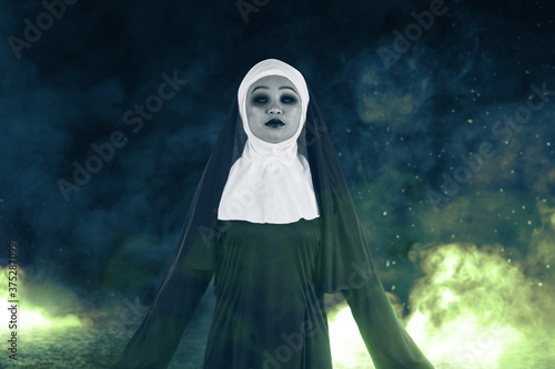 Scary devil nun standing