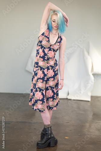 Portrait of tall, slim young woman dressed in fun urban attire.