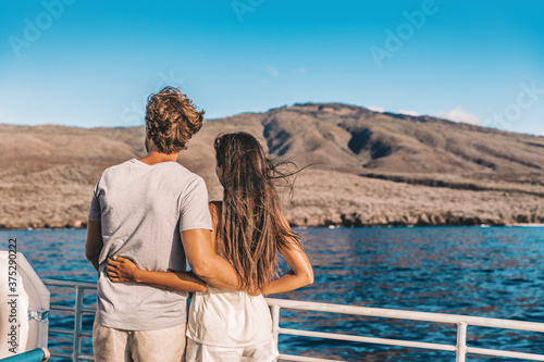 Cruise vacation couple tourists in love whale watching at sunset on ship deck outside. Happy travel vacation lifestyle. © Maridav