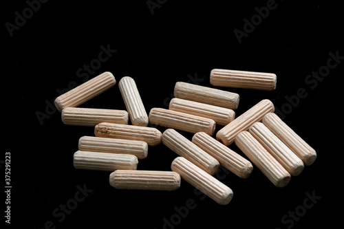 Group of wooden dowels for furniture assembly, work at home.