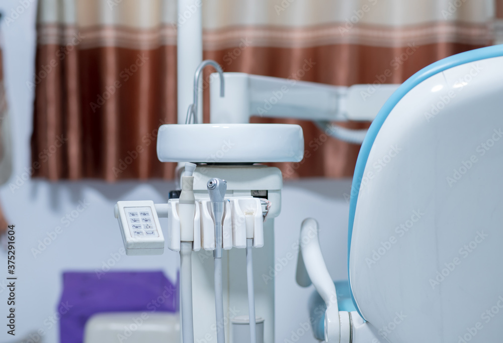 Metallic dentist tools close up on a dentist chair in Dentist Clinic Metallic dentist tools close up on a dentist chair in Dentist Clinic