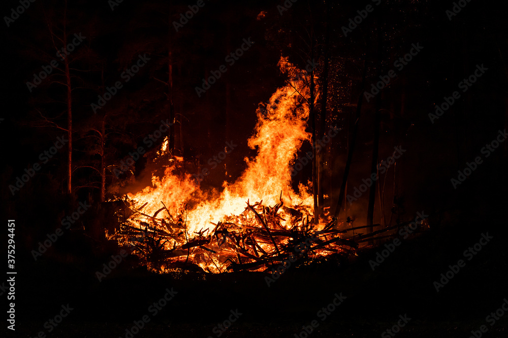 Big flames of forest fires at night. Intense flames from a massive forest fire Big flames of forest fires at night. Intense flames from a massive forest fire