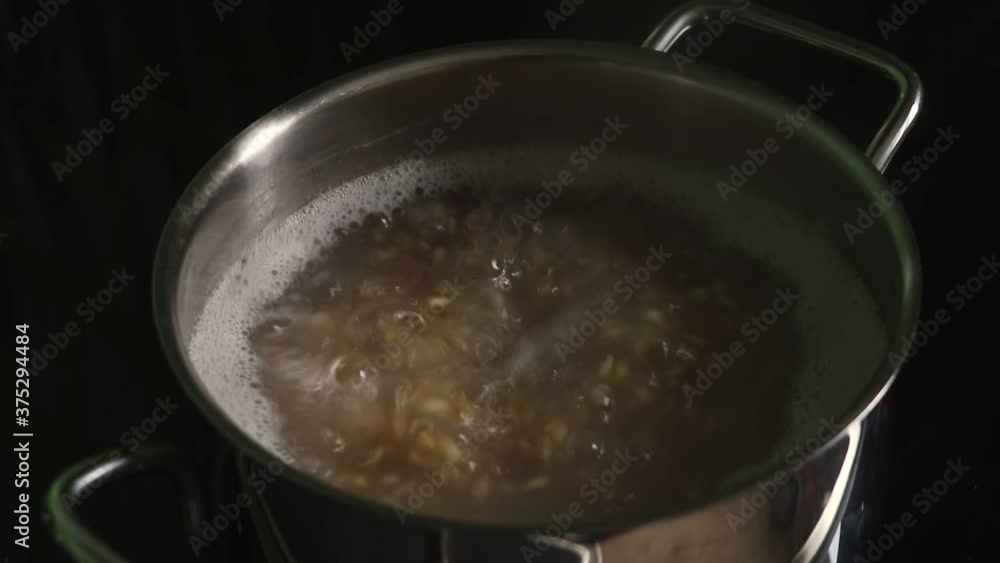 Cooking food in a saucepan on the stove. Cooking cereals. Cooking food in a saucepan on the stove. Cooking cereals.