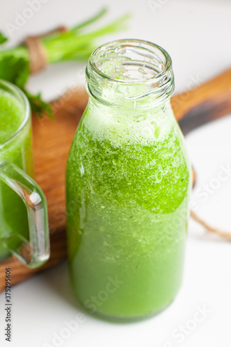 Organic cold-pressed raw vegetable juice. Cucumber drink with herbs.