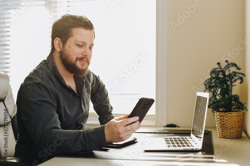 European businessman using smatrphone and laptop working at office. photo