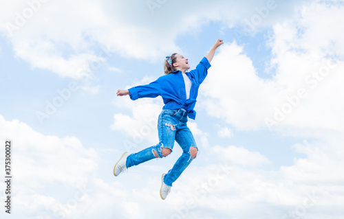happy childhood. smiling child jumping so high. carefree and joyful. kid fashion style. teenage girl on sky background outdoor. hipster kid jump. happy childrens day. Looking trendy