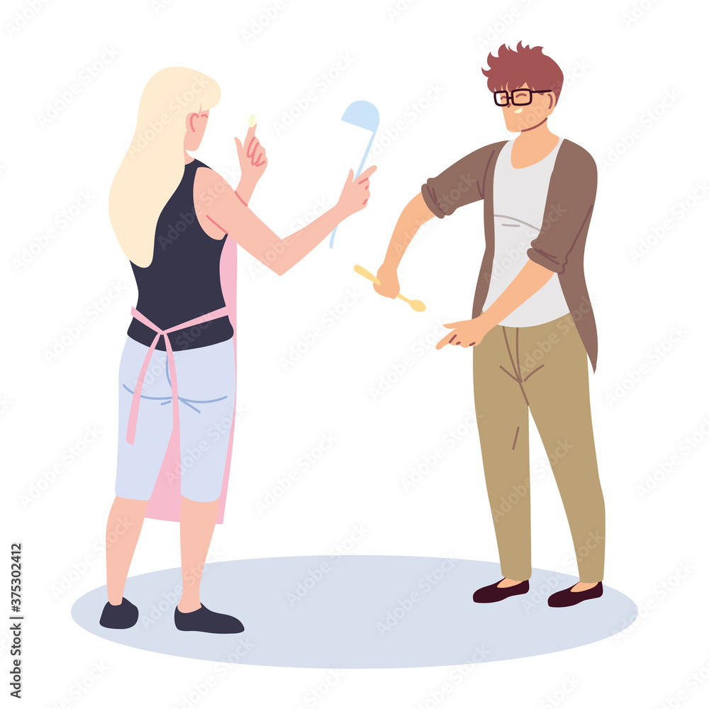 young couple cooking with apron and kitchen utensils young couple cooking with apron and kitchen utensils