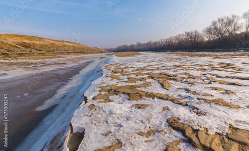 Hoarfrost and fresh powder snow in winter  on a wild  beautiful  river bank