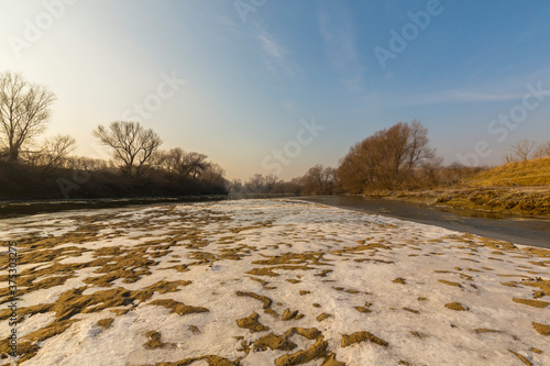 Hoarfrost and fresh powder snow in winter, on a wild, beautiful, river bank © Calin Tatu