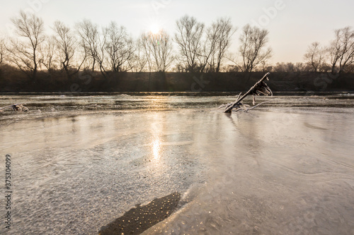 Hoarfrost and fresh powder snow in winter, on a wild, beautiful, river bank photo