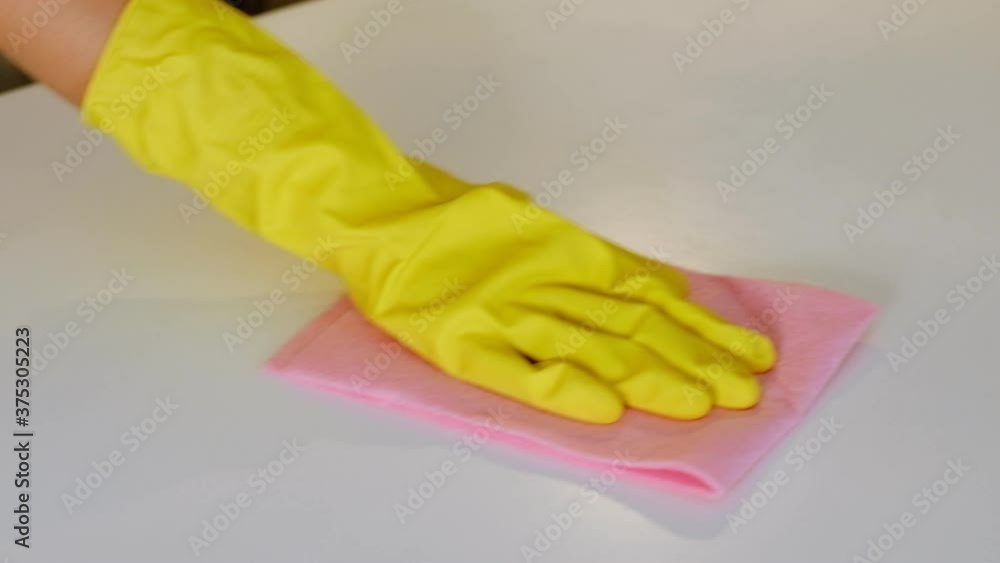 hand with rubber glove cleaning table with sponge and detergent. hand with rubber glove cleaning table with sponge and detergent hand with rubber glove cleaning table with sponge and detergent. hand with rubber glove cleaning table with sponge and detergent