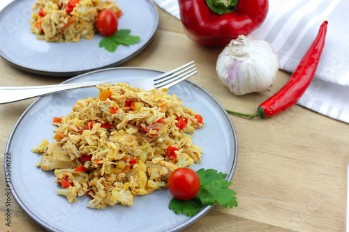 Cauliflower rice and chicken on a wooden board