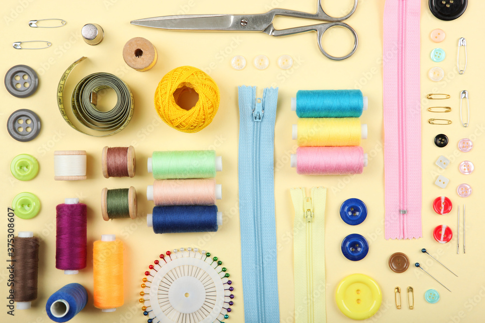 different sewing accessories on the table. Threads, needles, pins, fabric and sewing scissors close up
different sewing accessories on the table. Threads, needles, pins, fabric and sewing scissors close up