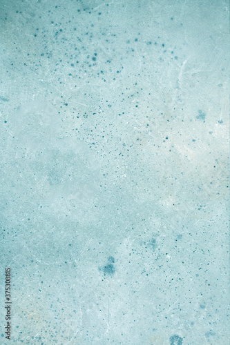 Light gray wall with abstract spots. Beautiful blue, white texture, abstract wall surface background, vintage surface texture with copy space, unusual spotty surface.