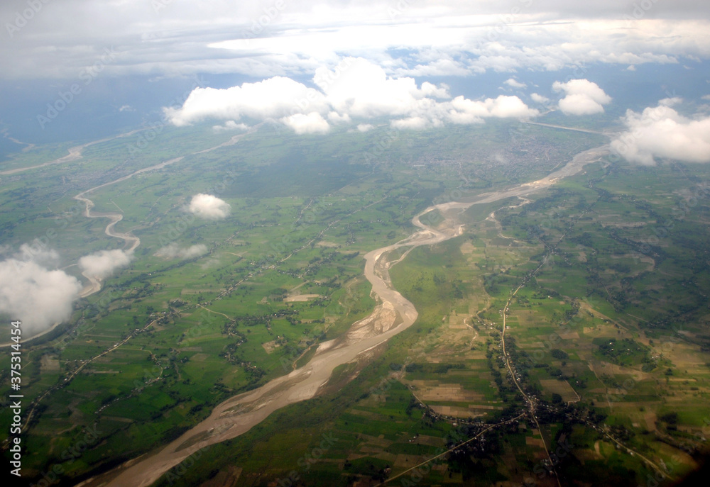 A spectacular aerial view of villages deviated with Mechi river with clouds as seen from flight during monsoon looks mesmerizing at Bhadrapur in Nepal.