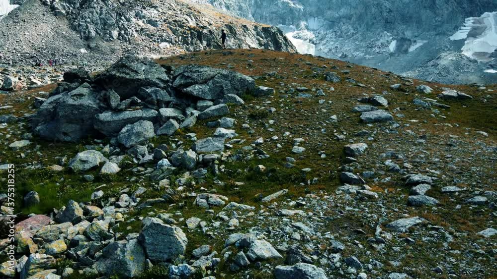 Tourist walks in a mountainous area at high altitudes Tourist walks in a mountainous area at high altitudes