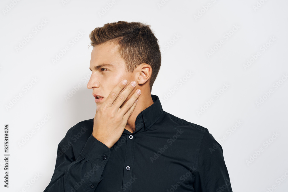 Man in black shirt lifestyle emotions modern style cropped view light background Man in black shirt lifestyle emotions modern style cropped view light background